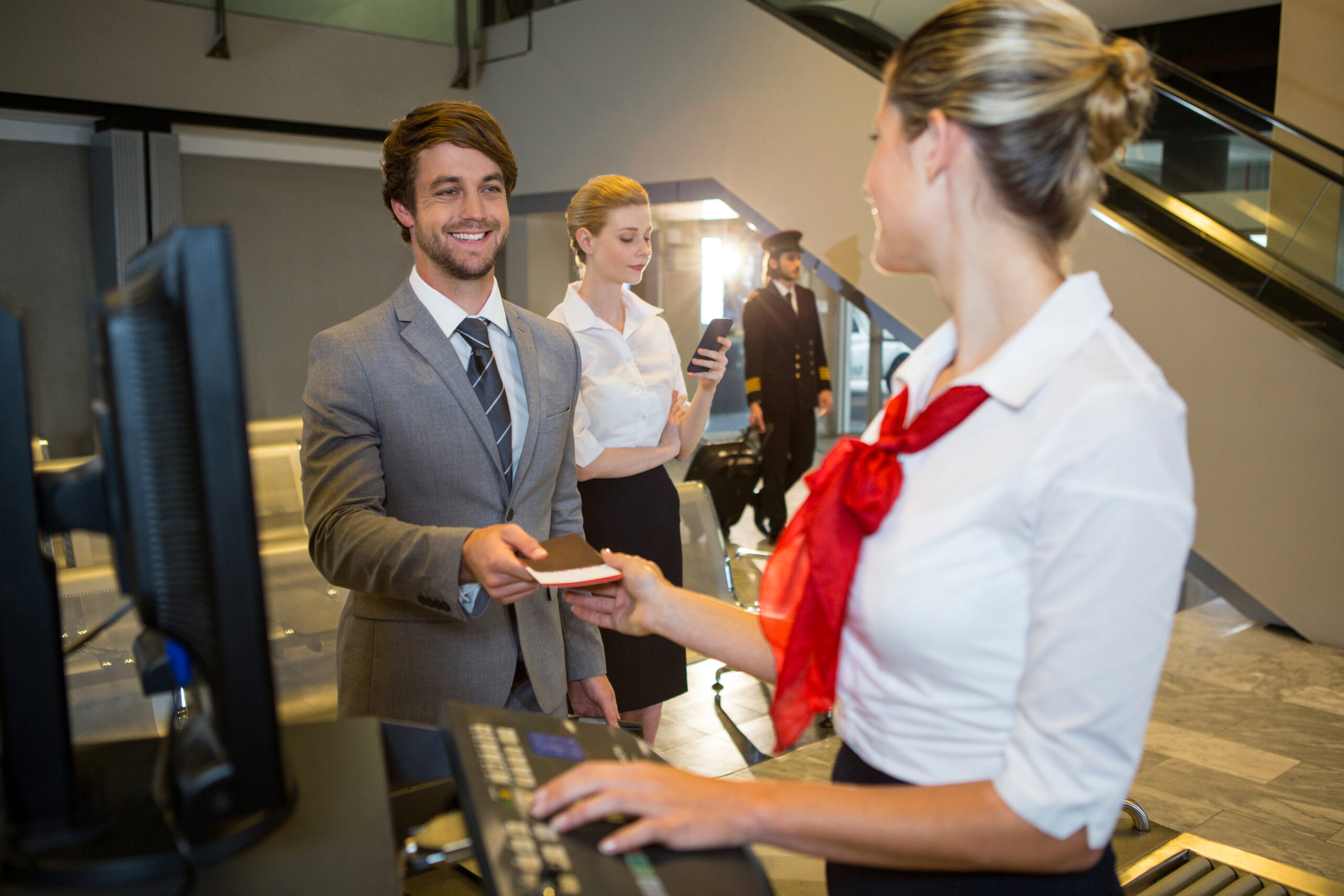 businessman-giving-his-boarding-pass-female-staff-check-desk